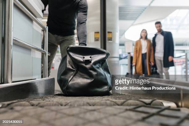 airport passenger loads luggage while checking in - pre positioned stock pictures, royalty-free photos & images