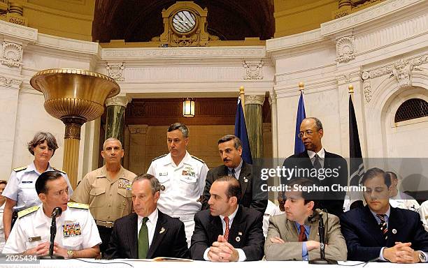 New York City Mayor Michael Bloomberg sits with members of the U.S. Military and New York City Council members as they listen to U.S. Navy Rear...