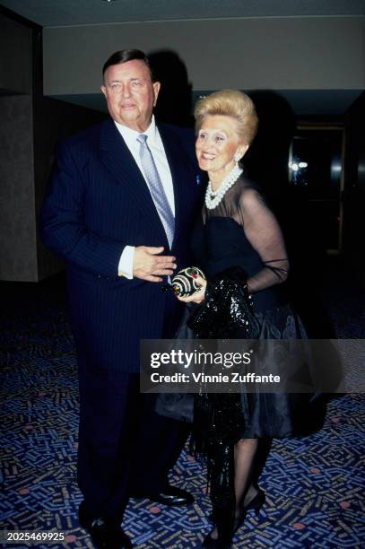 American industrialist Marvin Davis, wearing a dark blue suit over a white shirt with a light blue tie, and his wife, American philanthropist Barbara...