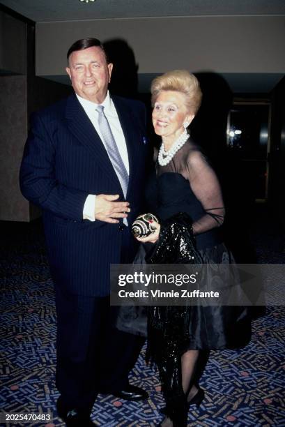 American industrialist Marvin Davis, wearing a dark blue suit over a white shirt with a light blue tie, and his wife, American philanthropist Barbara...