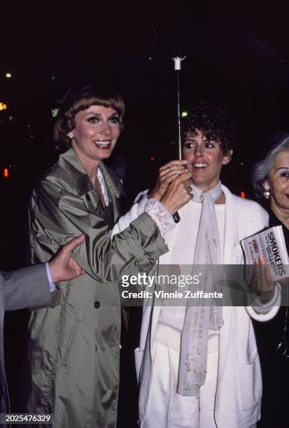 American actress and singer Inga Swenson, wearing a green coat, and American actress Pam Dawber, who wears a knitted white outfit with a white scarf,...