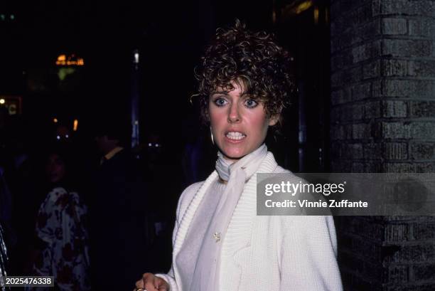 American actress Pam Dawber, wearing a knitted white outfit with a white scarf, United States, circa 1983.