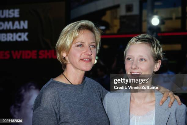 American television host and comedian Ellen DeGeneres, wearing a grey crew neck top, and American actress Anne Heche, who wears a grey suit over a...