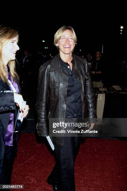 American singer, songwriter and guitarist Melissa Etheridge, wearing a black jacket over a purple shirt, and American television host and comedian...