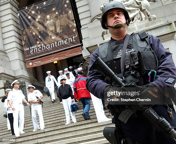 Heavily armed New York City Emergency Services Unit Police Sergeant Peter Smith stands guard in front of the U.S. Customs House as members of the...