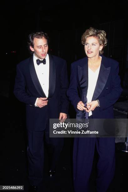 American actor Arye Gross, wearing a tuxedo and bow tie, and American television host and comedian Ellen DeGeneres, who wears a tuxedo over a white...