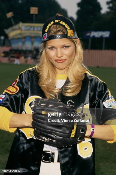 American actress and glamour model Donna D'Errico, wearing catching mitt and a reversed baseball cap, as she attends MTV's Annual Rock 'n Jock...