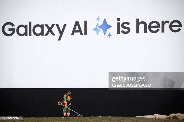 Worker uses a strimmer to cut the grass outside Fira Barcelona, venue of the Mobile World Congress , in Barcelona on February 23, 2024. The world's...