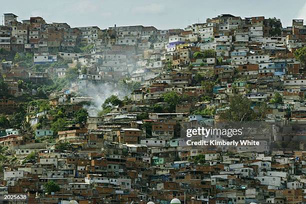 Hillside slums are shown May 21, 2003 in Caracas, Venezuela. The Central Bank reported May 23, 2003 Venezuela's economy is down 29 percent in the...