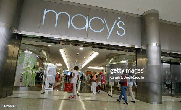 Customers walk out of Macy's the day after the company announced that the 56 Burdines stores and the seven Macy's stores in Florida all will operate...
