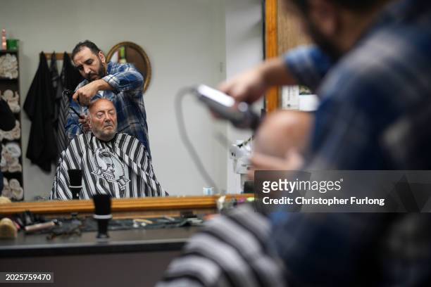 Workers party of Britain candidate George Galloway takes a break from canvassing in the Rochdale by-election with a haircut and wet shave from local...