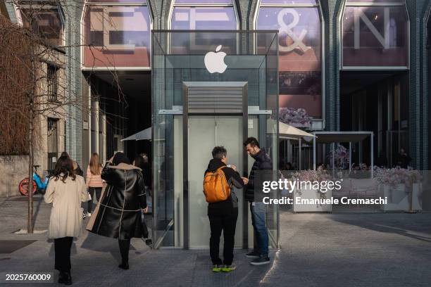 People stand in front an elevator taking to the Apple Inc. Store on February 20, 2024 in Piazza del Liberty, Milan, Italy. As reported by the...