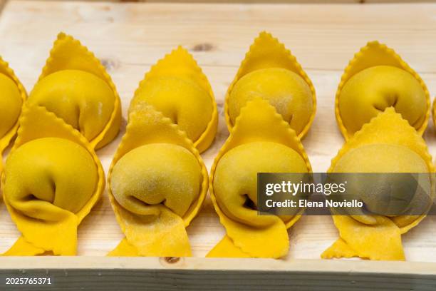 traditional italian fresh pasta tortellini. - tortellini stock pictures, royalty-free photos & images