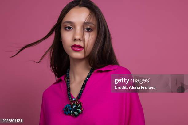 beautiful  young woman standing and smiling and dressing magenta jumper, leather trousers pink background springtime facial emotion fashion beauty - teen boots russian stock pictures, royalty-free photos & images