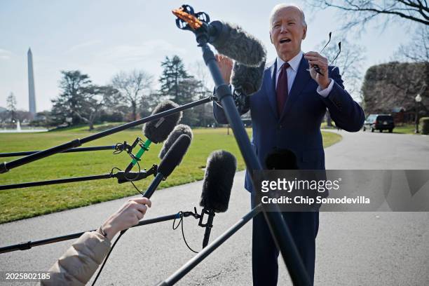 President Joe Biden stops to talk to journalists about new Russian sanctions as he departs the White House on February 20, 2024 in Washington, DC....