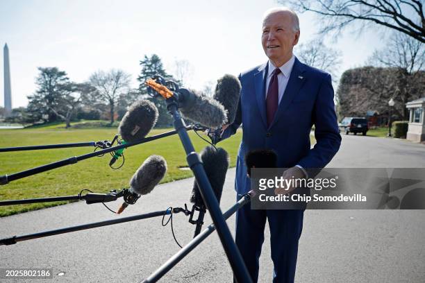 President Joe Biden stops to talk to journalists about new Russian sanctions as he departs the White House on February 20, 2024 in Washington, DC....