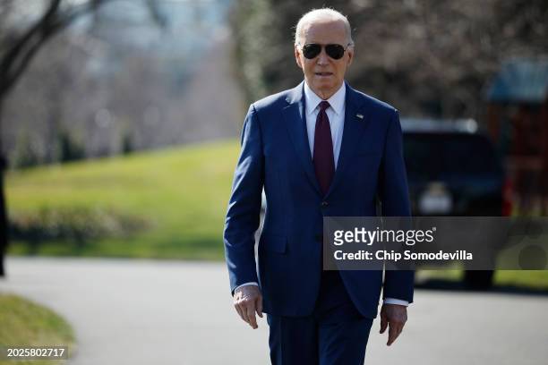 President Joe Biden walks over to journalists to talk about new Russian sanctions as he departs the White House on February 20, 2024 in Washington,...