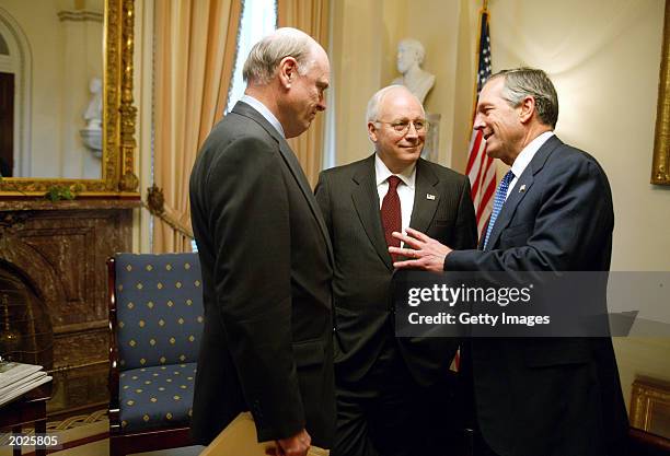 This handout photo from the White House shows U.S. Vice President Dick Cheney speaking with with Secretary of the Treasury John Snow and Secretary of...