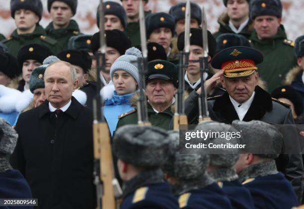 Russian President Vladimir Putin and Defence Minister Sergei Shoigu looks on while taking part in the wreath laying ceremony at the Unknown Soldier...