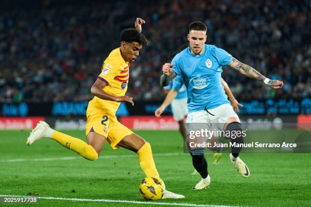 Lamine Yamal of FC Barcelona duels for the ball with Mihailo Ristic of RC Celta Vigo during the LaLiga EA Sports match between Celta Vigo and FC...