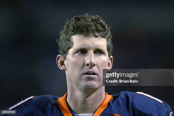 Quarterback Steve Beuerlein of the Denver Broncos walks on the sideline late in the fourth quarter after starting the game against the Arizona...