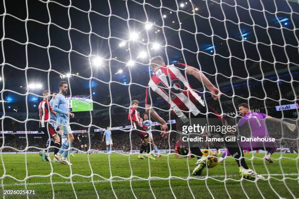 Ben Mee of Brentford makes a goal line clearance following a shot from Oscar Bobb of Manchester City during the Premier League match between...