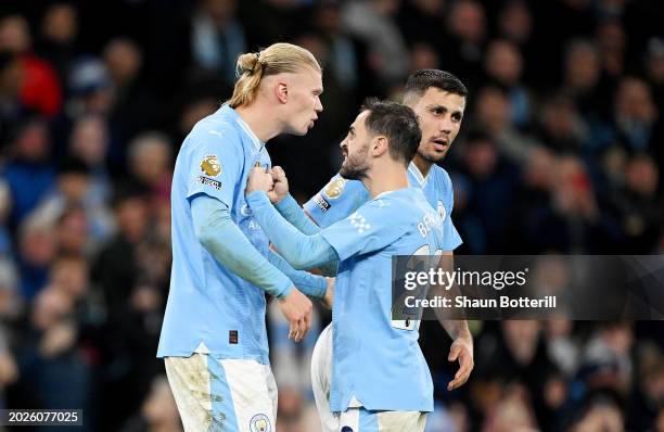 Erling Haaland of Manchester City celebrates with Bernardo Silva and Rodri of Manchester City after scoring his team's first goal during the Premier...