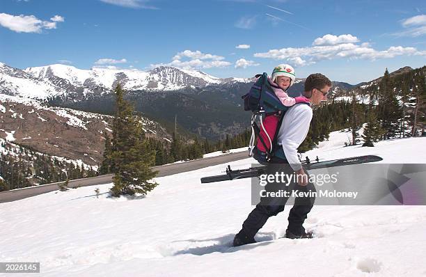 Danny Basch, of Estes Park, Colorado packs his daughter Annalise for a ski run above Trail Ridge Road May 23, 2003 in Rocky Mountain National Park,...