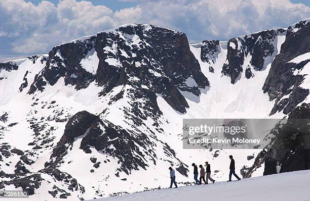 People walk near the Trail Ridge Road May 23, 2003 in Rocky Mountain National Park, Colorado. The road was opened for the season May 23 after crews...