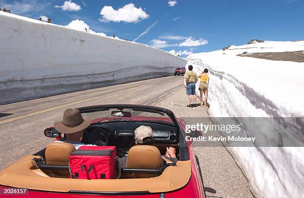 Tourists travel along Trail Ridge Road Road May 23, 2003 in Rocky Mountain National Park, Colorado. The road was opened for the season May 23 after...