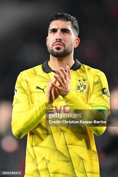 Emre Can of Borussia Dortmund applauds the fans at full-time following the team's draw in the UEFA Champions League 2023/24 round of 16 first leg...