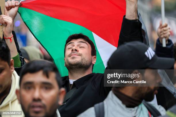 Man with a Palestinian flag during the demonstration in Naples, in solidarity with the Palestinian people, and against the massive Israeli attacks on...