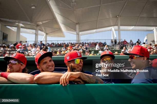 Luis Perales, Luis Guerrero, Jorge Benitez, and Bryan Mata of the Boston Red Sox react in the dugout before a game against the Northeastern Huskies...