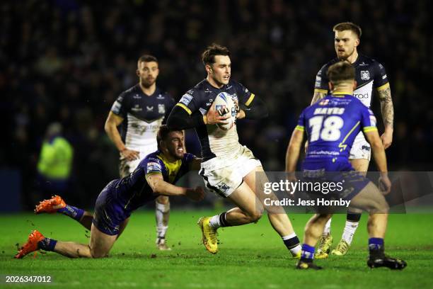 Tex Hoy of Hull FC is tackled by Adam Holroyd of Warrington Wolves during the Betfred Super League match between Warrington Wolves and Hull FC at The...