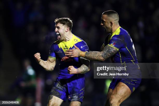 Sam Powell of Warrington Wolves celebrates with teammate Paul Vaughan after scoring his team's third try during the Betfred Super League match...