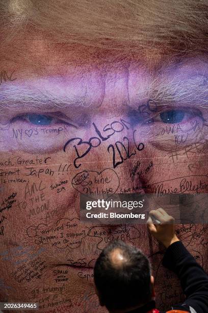 An attendee signs the "Magabus" during the Conservative Political Action Conference in National Harbor, Maryland, US, on Friday, Feb. 23, 2024. The...