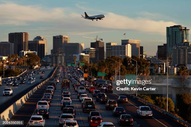 Traffic backs up on southbound Interstate 5 heading into downtown during rush hour as a Delta Connection operated by SkyWest Airlines Embraer E175LR...