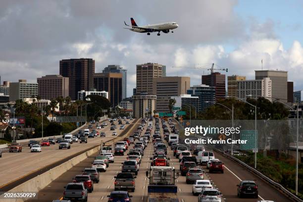 Delta Airlines Airbus A321-211 flies over traffic on southbound Interstate 5 as it approaches San Diego International Airport for a landing on a...