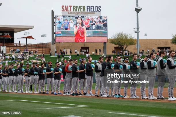 The Arizona Diamondbacks line up for the nation anthem before the MLB spring training baseball game between the Arizona Diamondbacks and the Colorado...