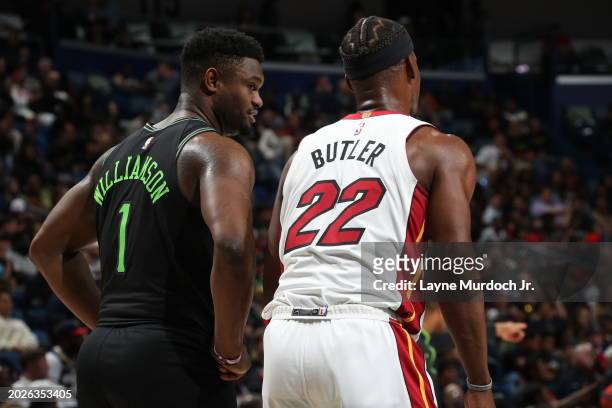 Zion Williamson of the New Orleans Pelicans talks with Jimmy Butler of the Miami Heat during the game on February 23, 2024 at the Smoothie King...