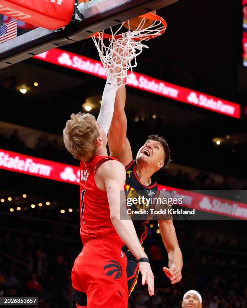 Bogdan Bogdanovic of the Atlanta Hawks goes up for a shot against Gradey Dick of the Toronto Raptors during the first quarter at State Farm Arena on...