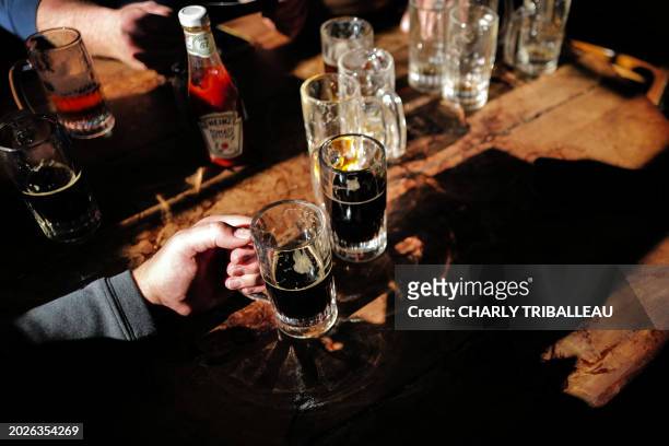 Customers are seen drinking beers at McSorley's Old Ale House in New York on February 18, 2024. Not much has changed in the 170 years that McSorley's...