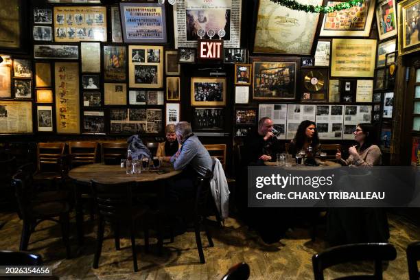 Customers are seen drinking beers at McSorley's Old Ale House in New York on February 18, 2024. Not much has changed in the 170 years that McSorley's...