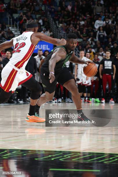 Zion Williamson of the New Orleans Pelicans handles the ball against Jimmy Butler of the Miami Heat during the game on February 23, 2024 at the...