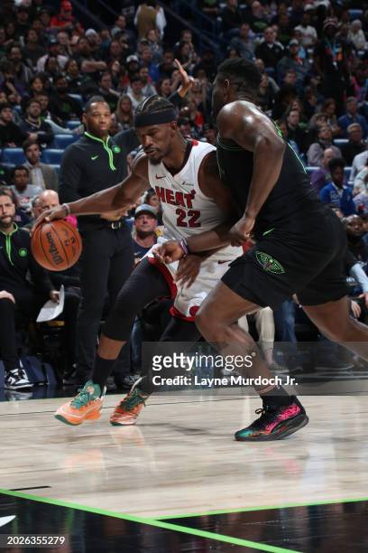 Jimmy Butler of the Miami Heat handles the ball against Zion Williamson of the New Orleans Pelicans during the game on February 23, 2024 at the...