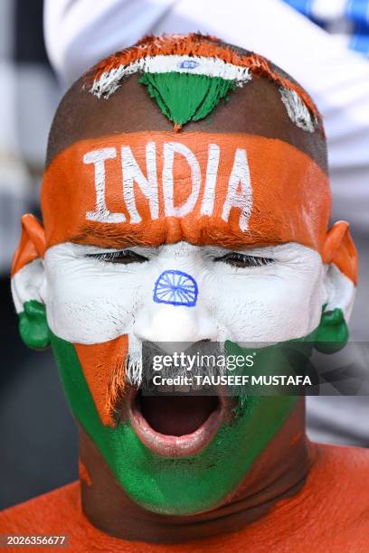Cricket fan with his face painted in the colours of the Indian flag cheers from the stands during the second day of the fourth Test cricket match...
