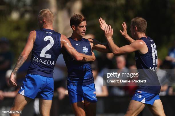 Jaidyn Stephenson of the Kangaroos celebrates with Jy Simpkin of the Kangaroos after kicking a goal during an AFL practice match between North...