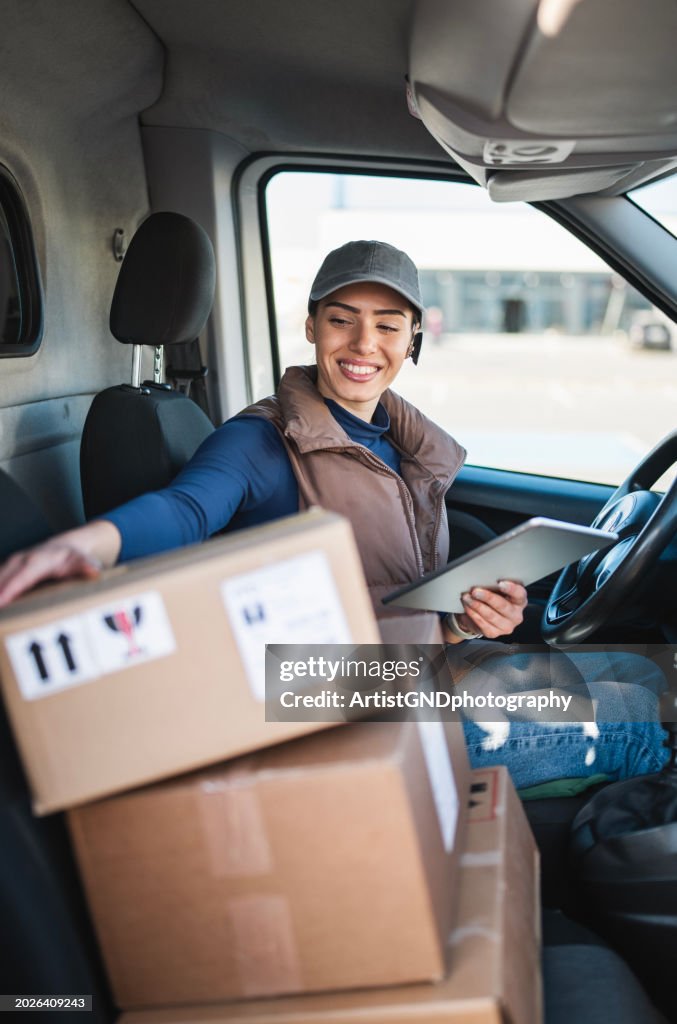 Courier checking the parcel for delivery.