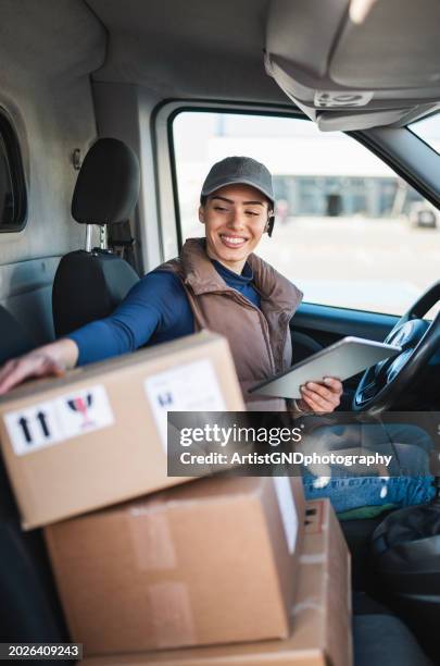 courier checking the parcel for delivery. - delivery person stock pictures, royalty-free photos & images