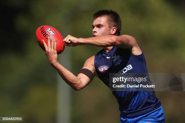 Colby McKercher of the Kangaroos handballs during an AFL practice match between North Melbourne Kangaroos and Collingwood Magpies at AIA Centre on...